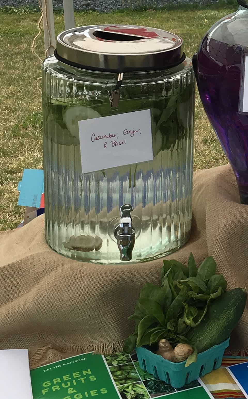 Photo of a beverage dispenser of Cucumber, Ginger, and Basil Infused Water. https://trimazing.com/