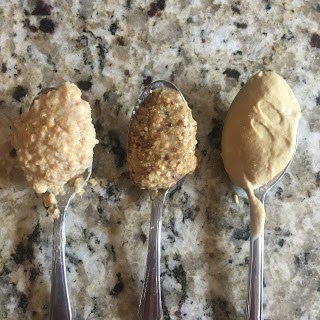 Photo three spoons containing Dijon mustard. Left is author