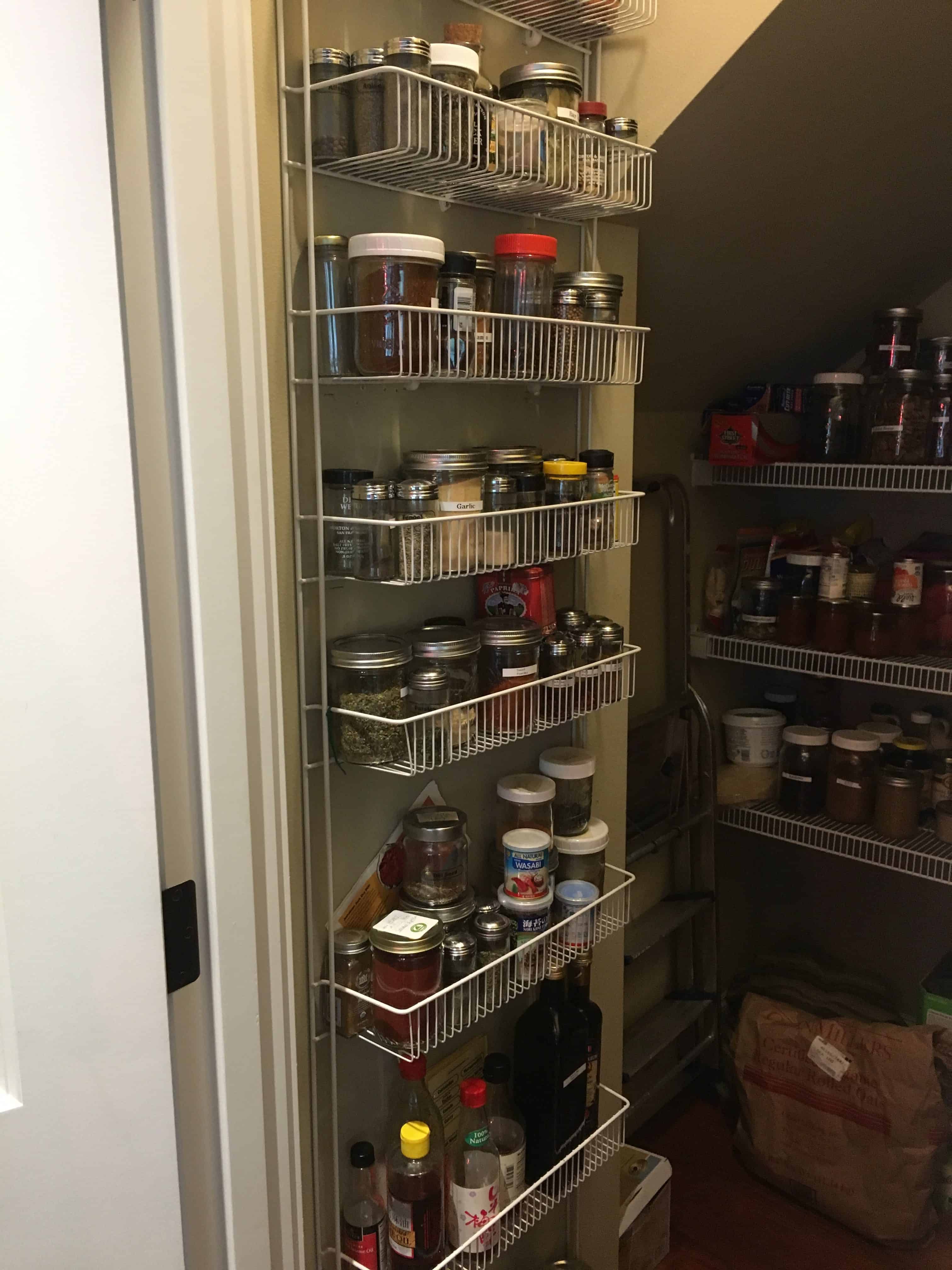 Walk-in pantry with shelves of glass storage spice jars full of vegan (whole food plant-based) foods https://trimazing.com/