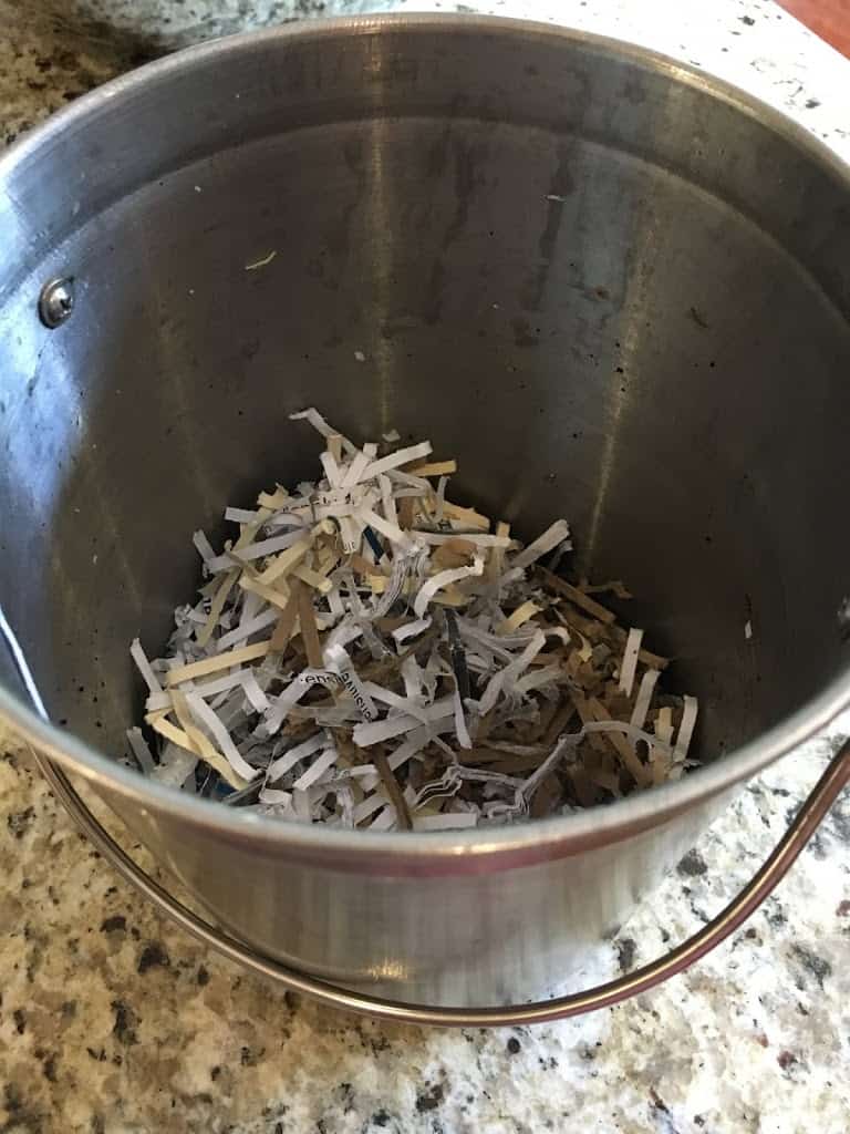 Paper shreds in bottom of compost pail. https://trimazing.com/ 