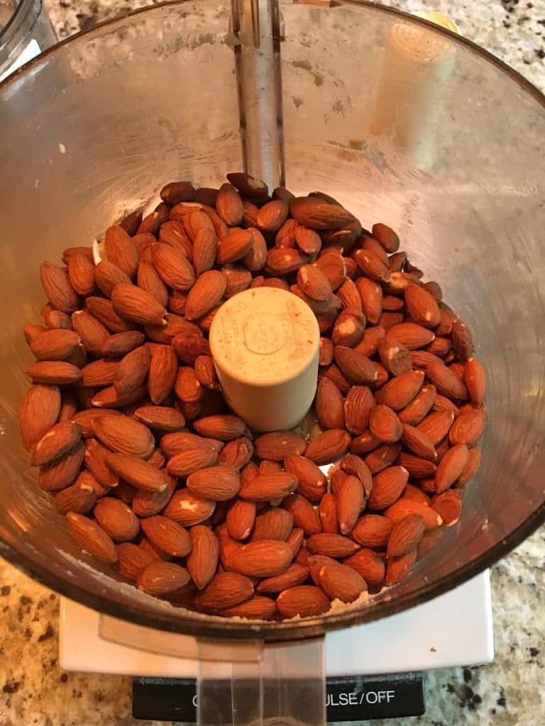 Raw almonds in food processor. https://trimazing.com/ 