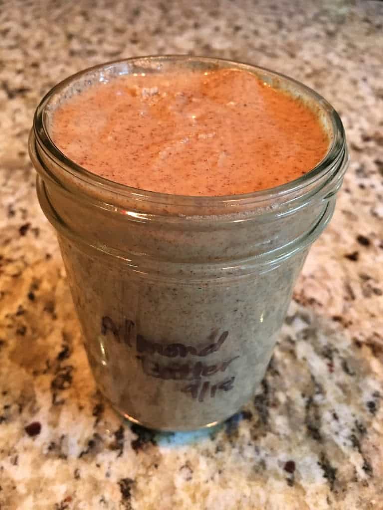 Pint jar of homemade raw almond butter. https://trimazing.com/