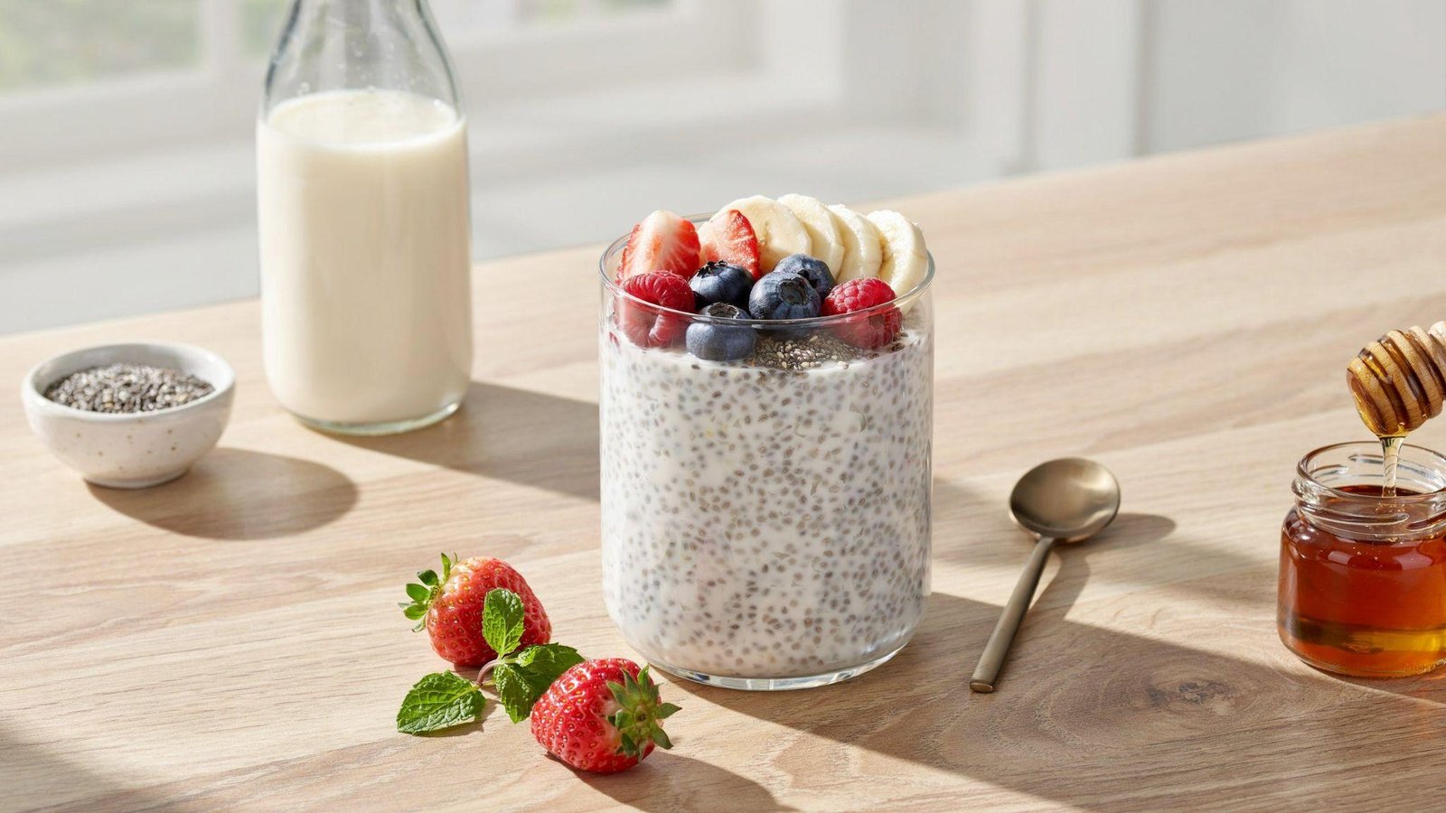 Single-serving chia pudding topped with fresh berries, banana slices, chia seeds, and wholesome breakfast ingredients