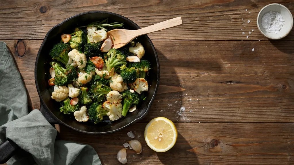 Sauteed broccoli and cauliflower with garlic served in a skillet.