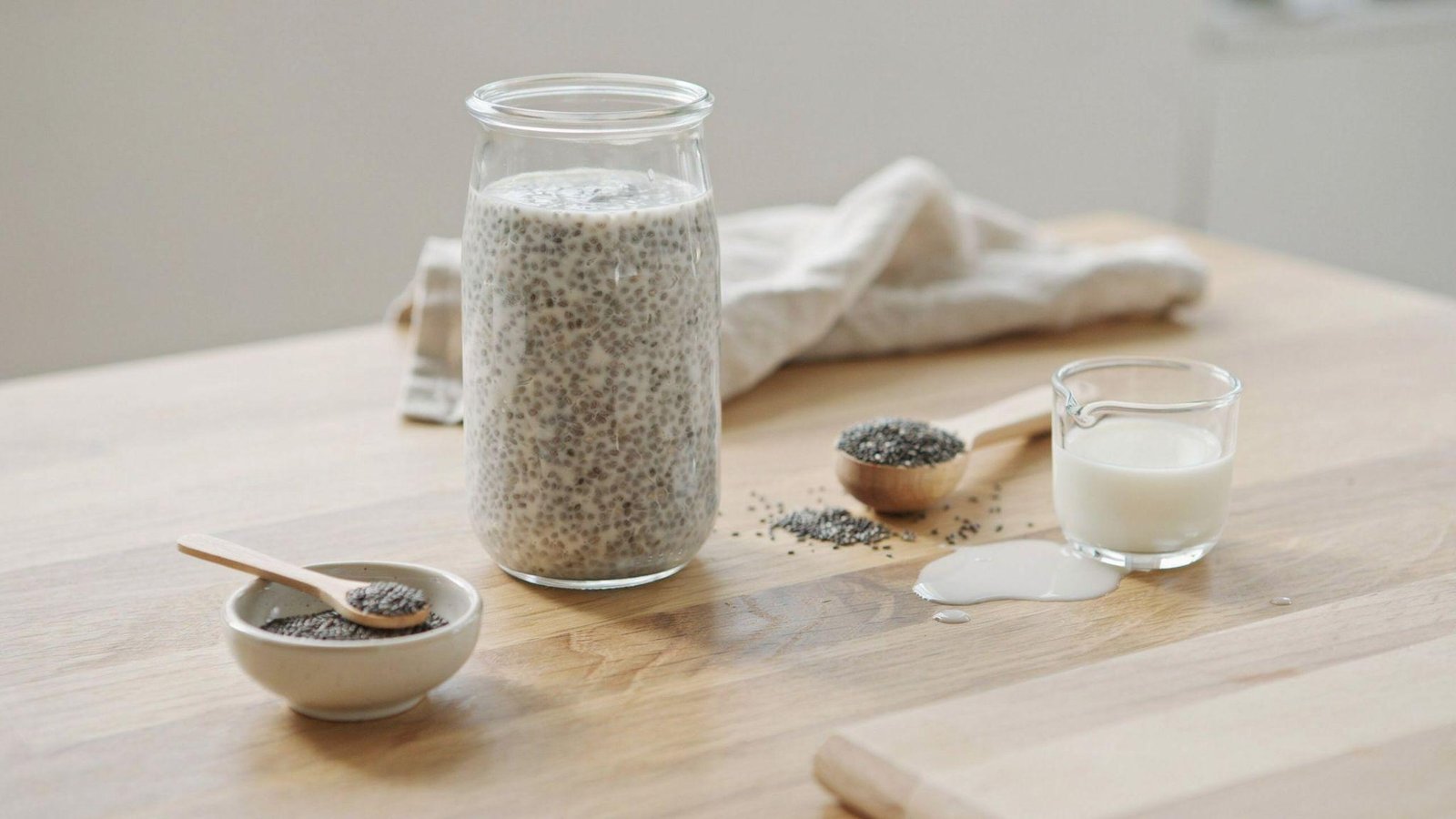 Perfect single-serving chia pudding with measured chia seeds, milk, and creamy thick consistency in a glass jar.