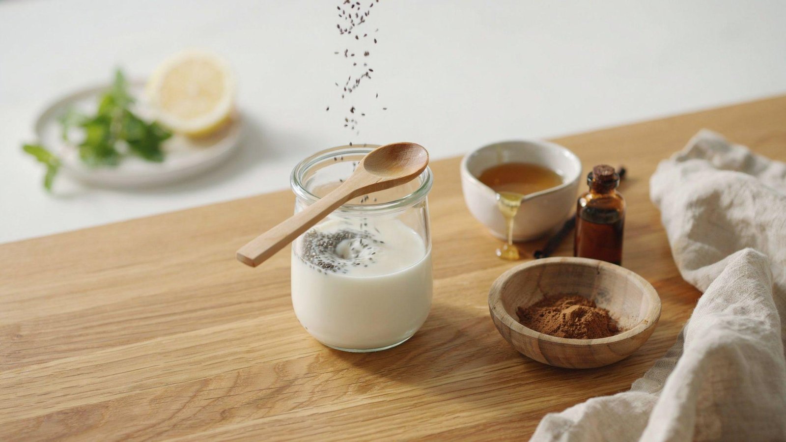 Chia seeds, milk, vanilla, cinnamon, and honey combined in a glass jar for pudding.