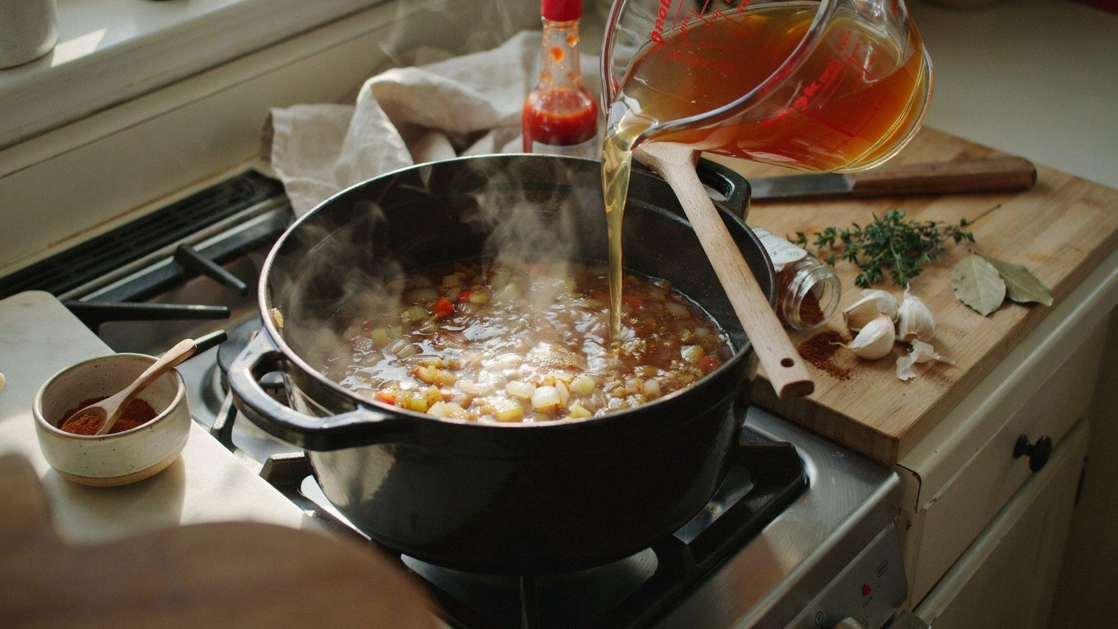 Low-sodium broth and Cajun seasonings added to healthy gumbo base in Dutch oven.