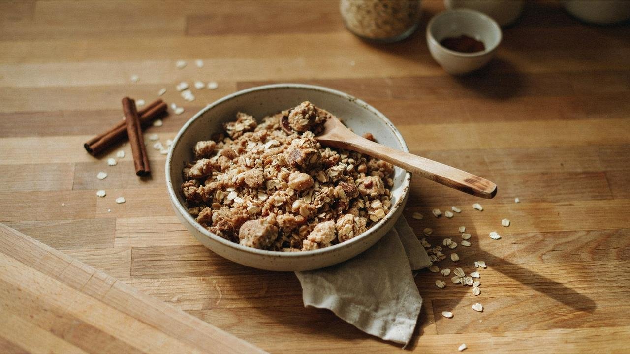 Bowl of crumbly oat streusel topping made with rolled oats, flour, cinnamon, and melted butter.