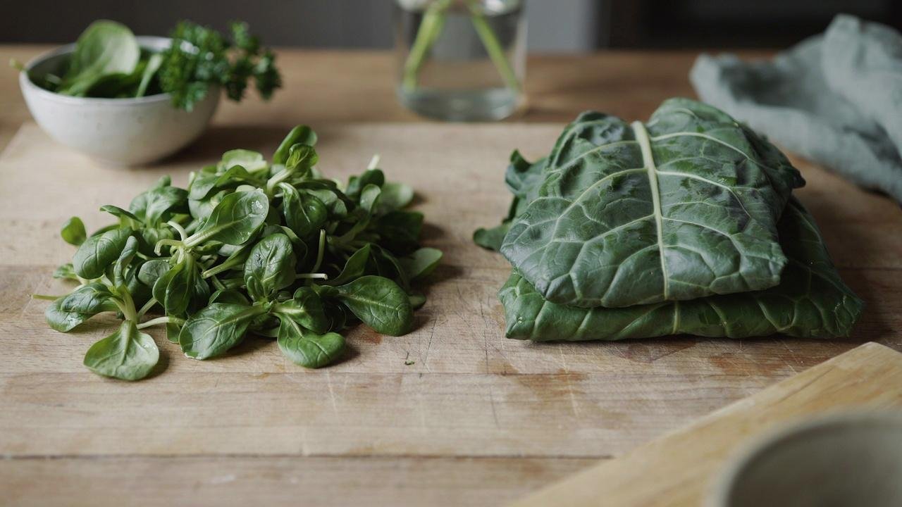 Baby spinach and collard greens shown side by side to compare textures.