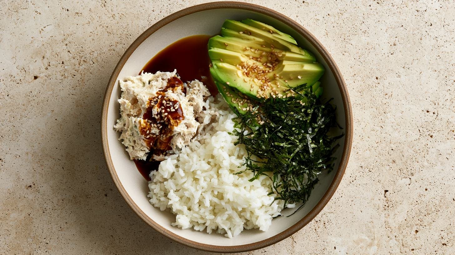 Japanese-influenced tuna avocado rice bowl with rice, tuna, avocado, and sesame seeds.