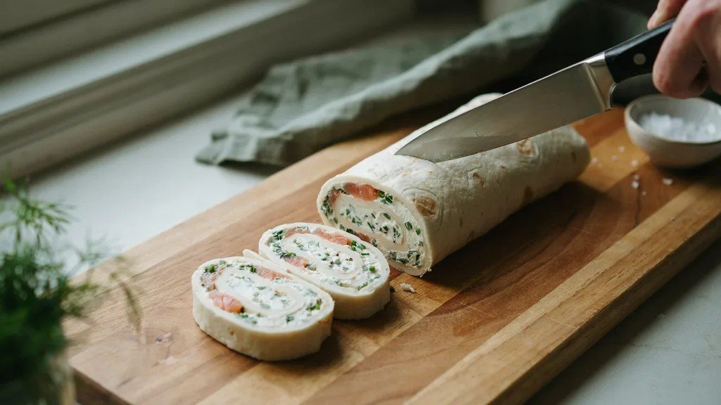 Rolled keto pinwheel wrapped before chilling.