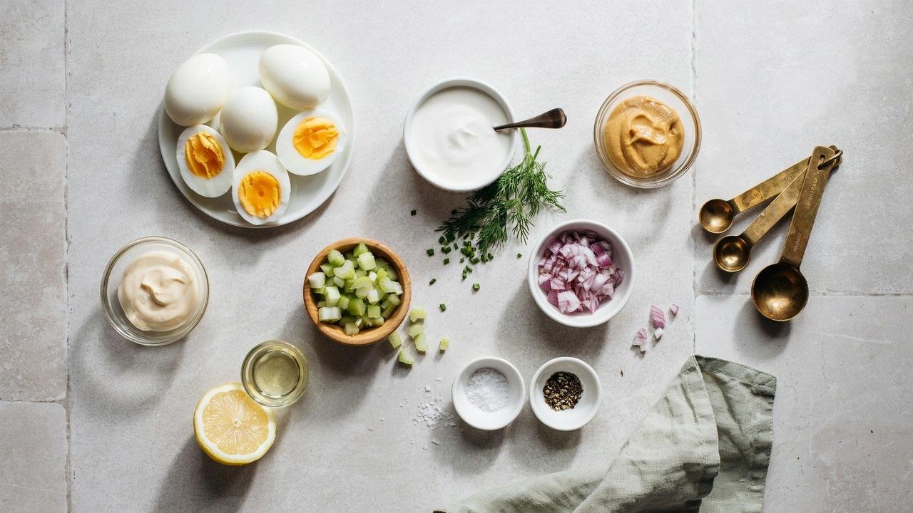 Simple ingredients for high protein egg salad arranged neatly on a countertop before mixing.