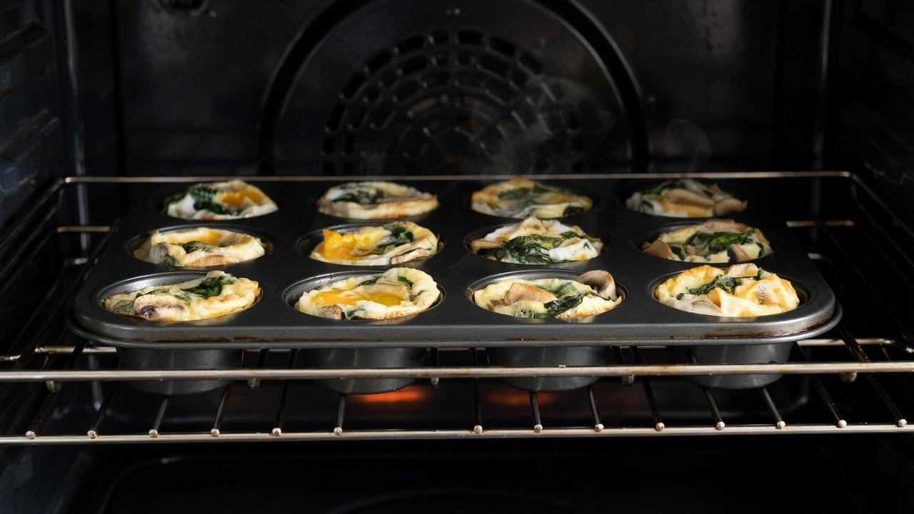 Spinach mushroom egg bites baking until golden and set.