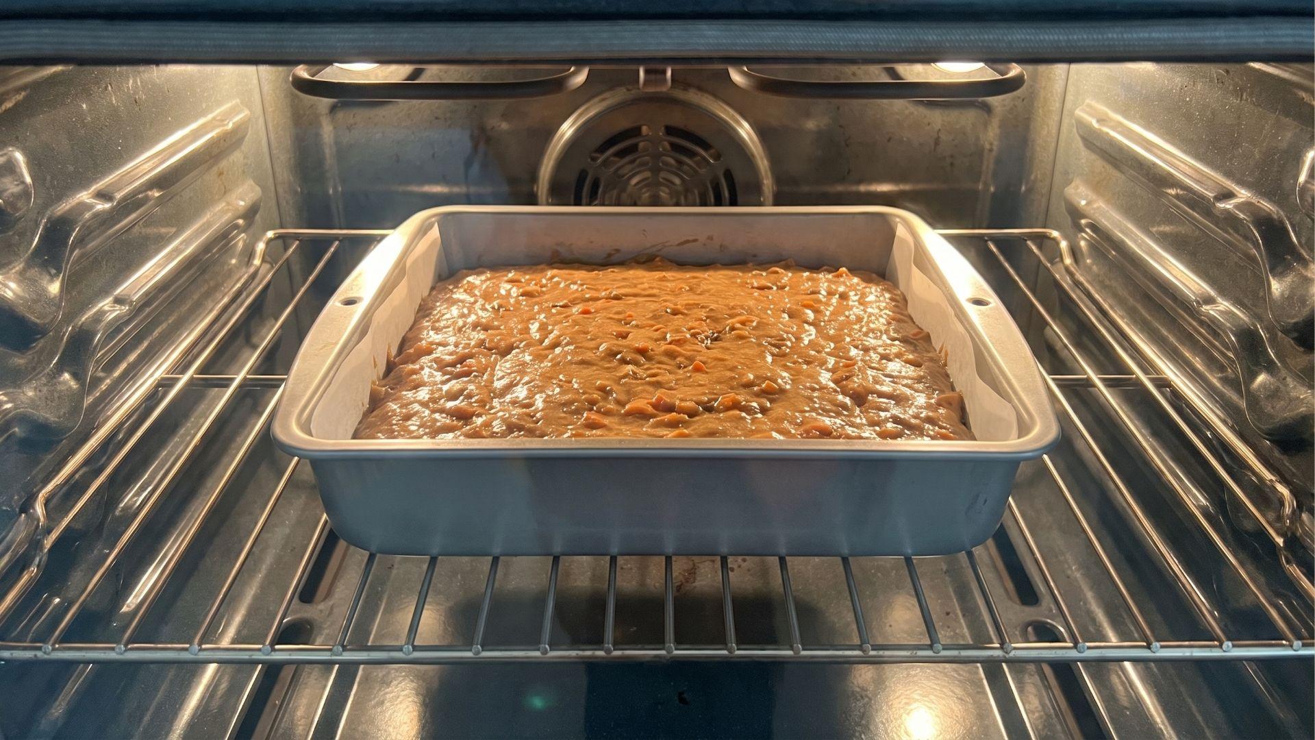 Carrot cake with raisins baking in a prepared pan