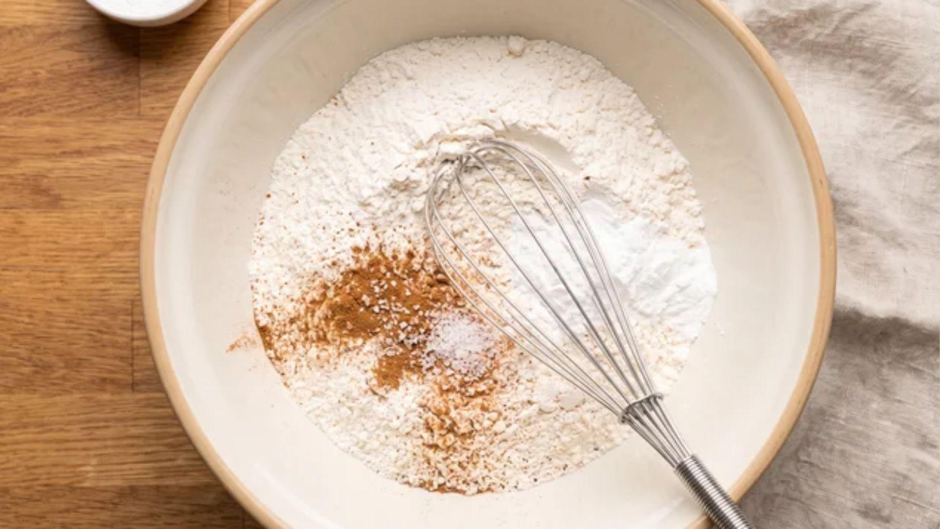Dry carrot cake ingredients mixed together in a bowl