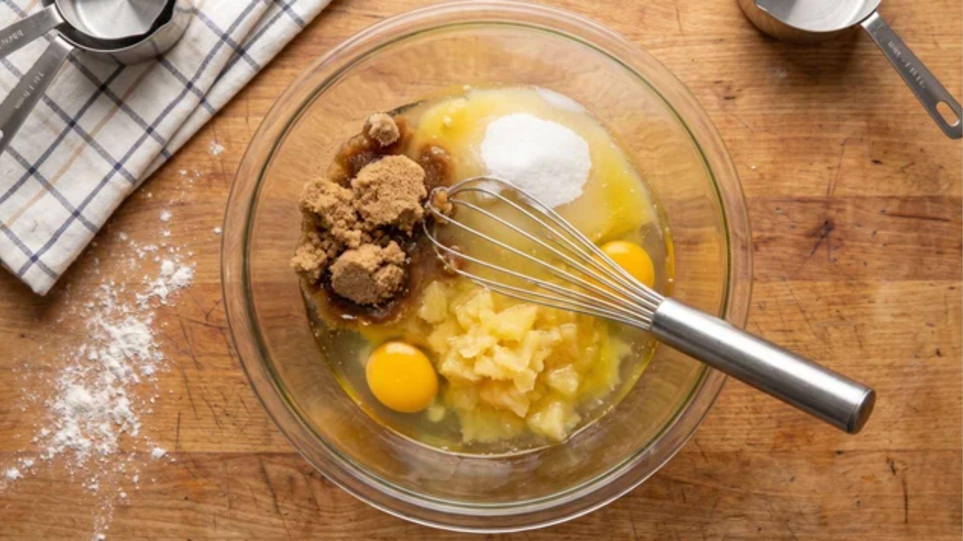 Wet ingredients mixed for carrot cake with pineapple and raisins