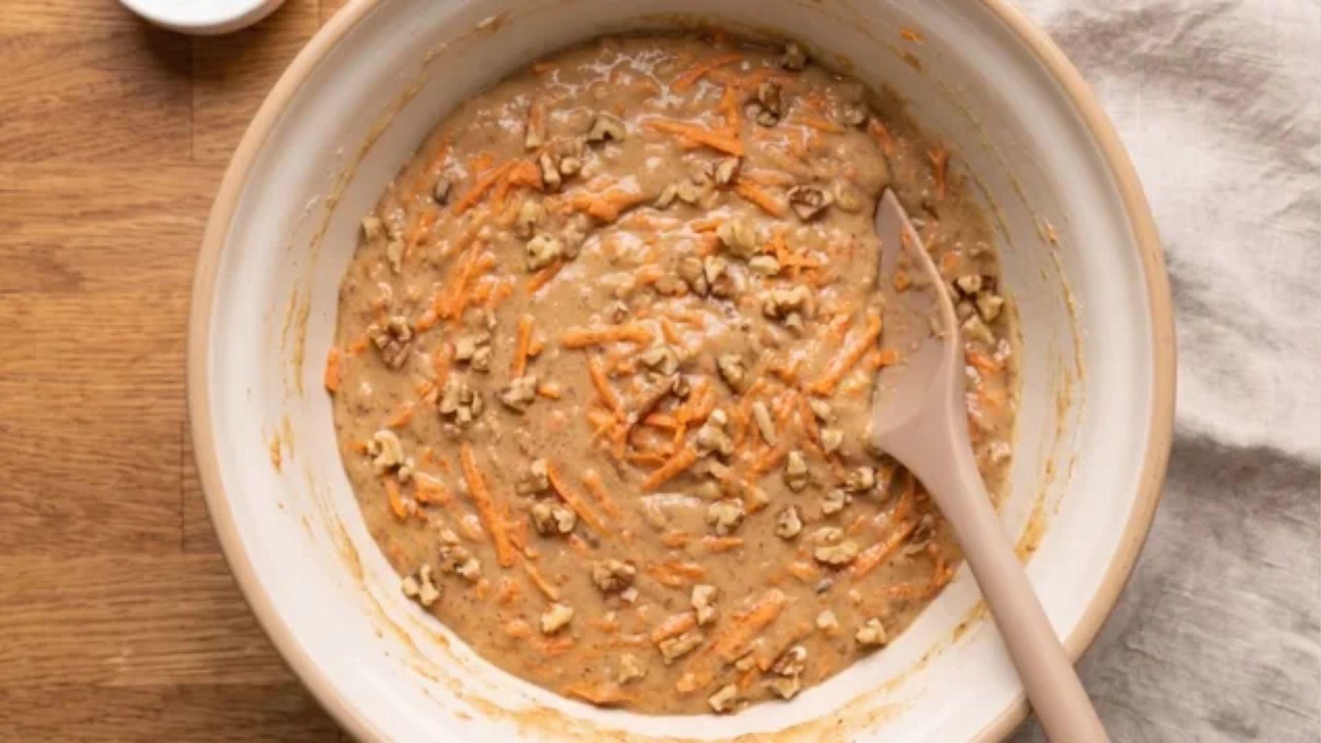 Grated carrots and walnuts folded into small carrot cake batter
