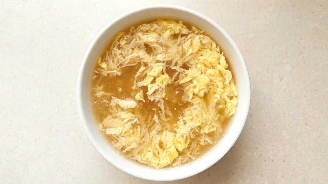 Egg drop soup with lightly beaten eggs in chicken broth
