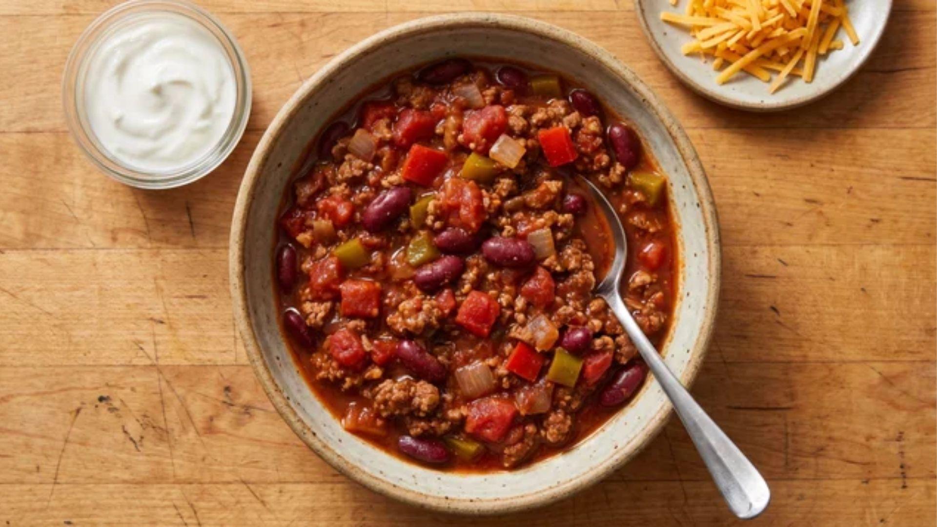 Healthy chili with lean meat, beans, vegetables, Greek yogurt, and cheese