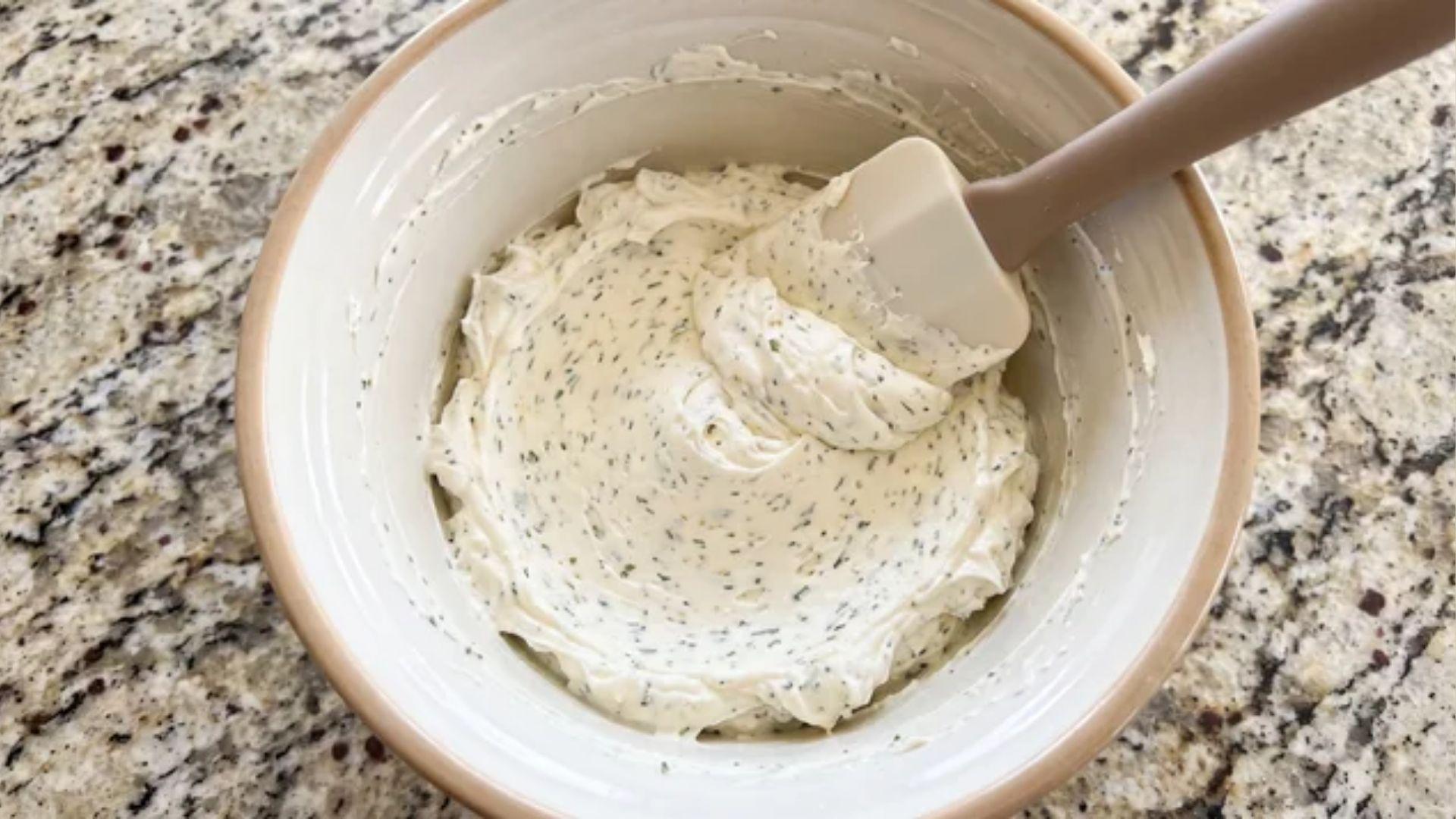 Softened cream cheese mixed with ranch seasoning in a bowl