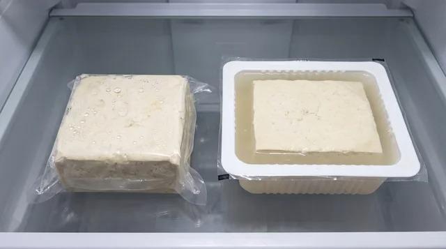 Sealed tofu block beside an opened container of tofu and packing liquid