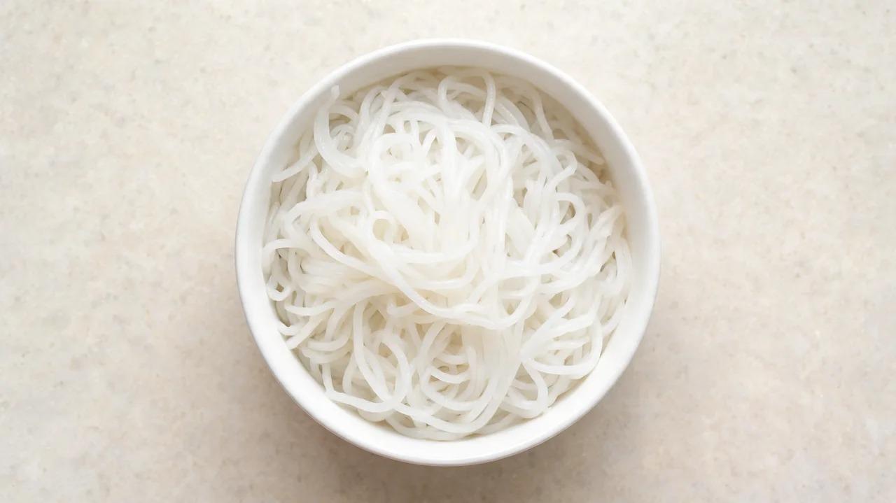 Cooked rice noodles arranged in a bowl
