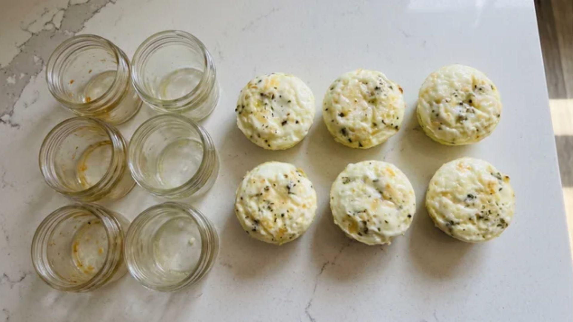 Cooked egg white bites resting beside small glass jars