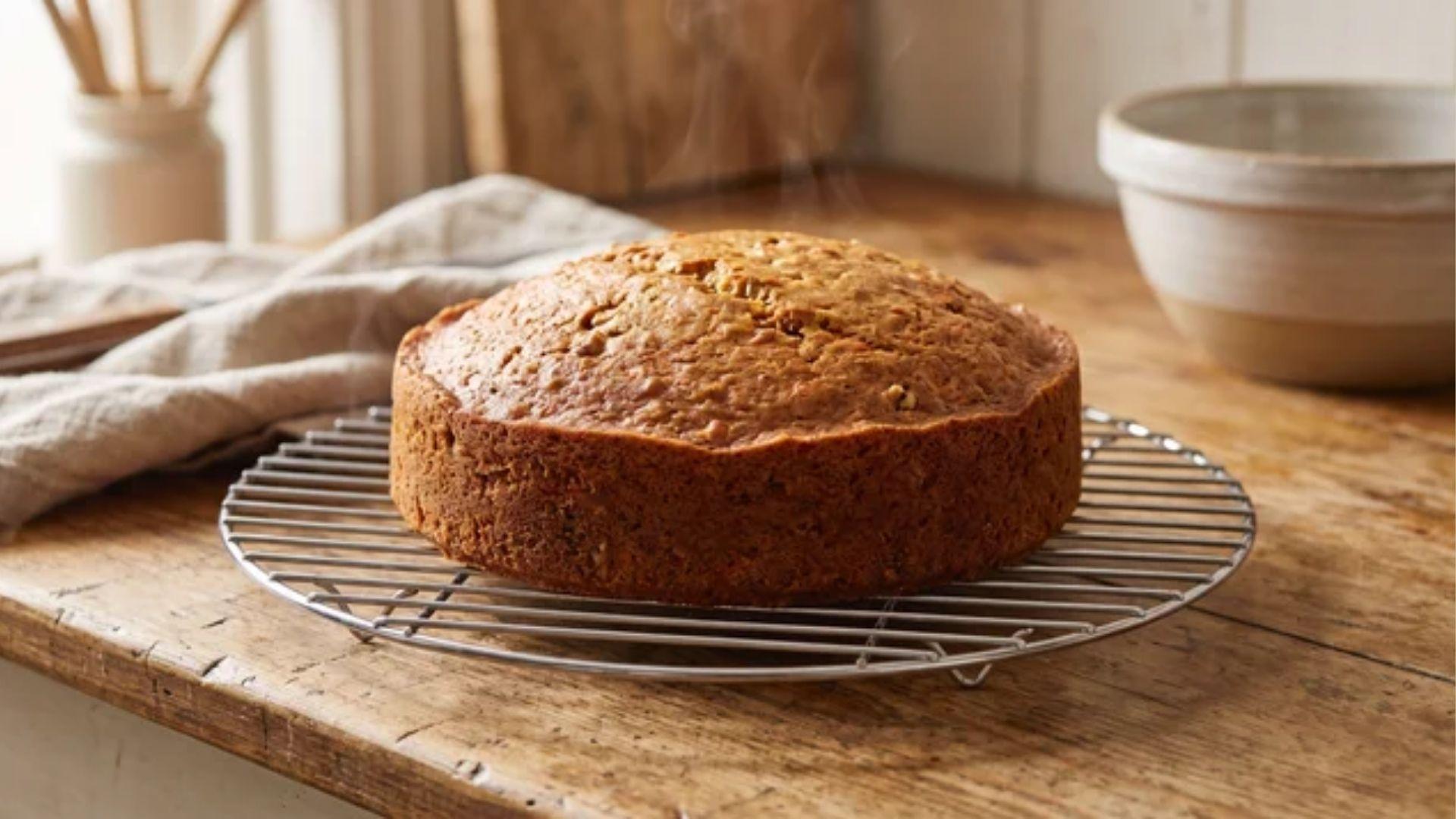 Small carrot cake cooling completely on a wire rack