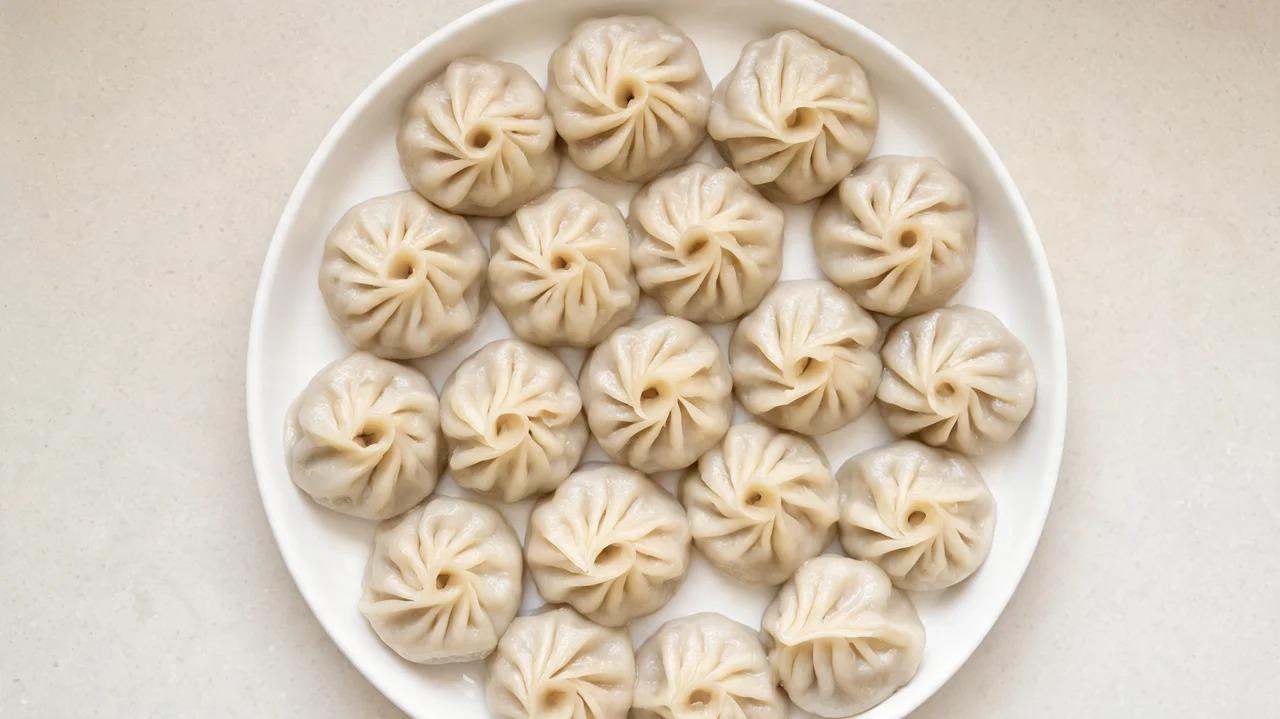Steamed dumplings arranged on a serving plate